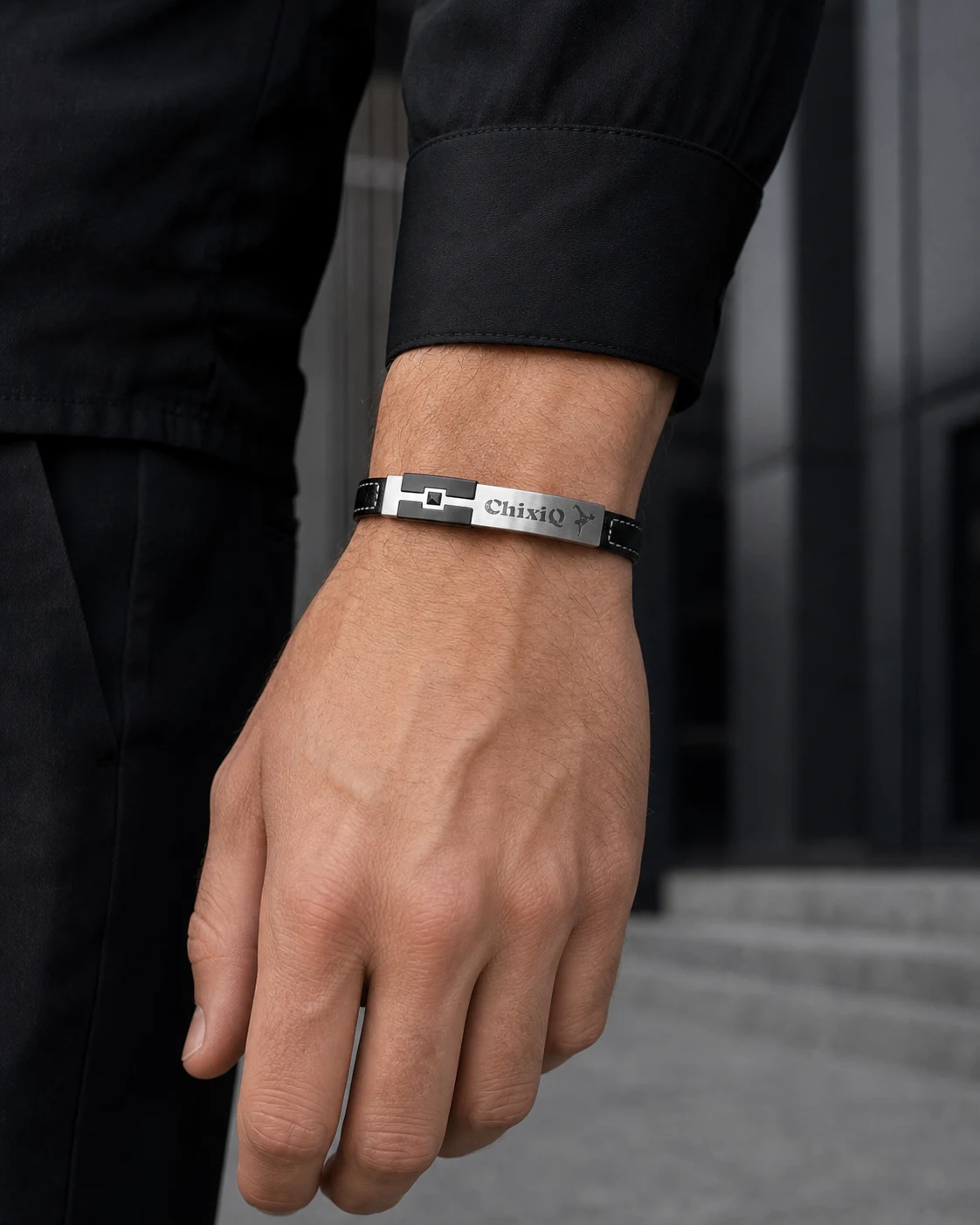 Black ChixiQ Founder Edition bracelet worn with a black long-sleeve shirt