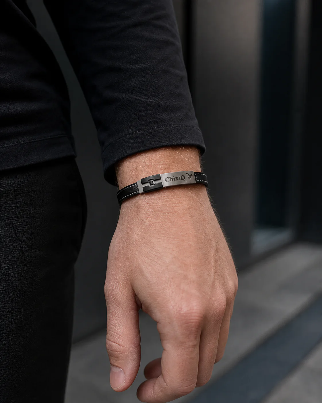 Black ChixiQ Founder Edition bracelet worn with a black long-sleeve shirt